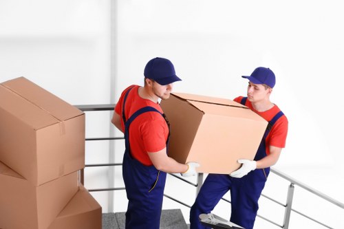 Furniture pick-up team handling a sofa collection in an Ealing home