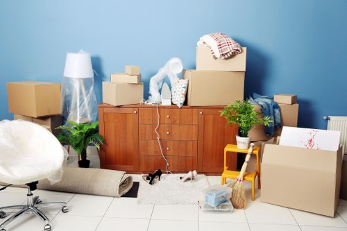 Moving team preparing boxes and furniture for a relocation in Ealing