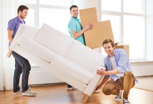 Professional removals team handling furniture access and loading in Ealing