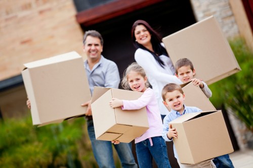 Professional movers handling office furniture during an Ealing move